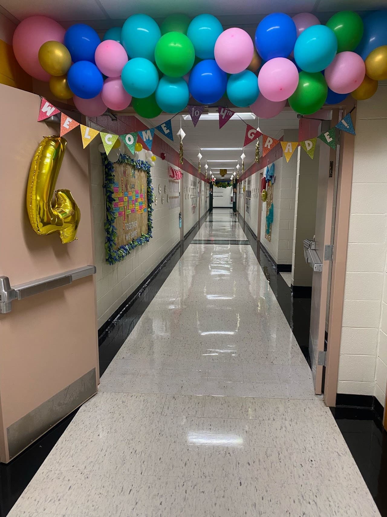 Colorful balloon garland decorating a school hallway for a grade-level celebration
